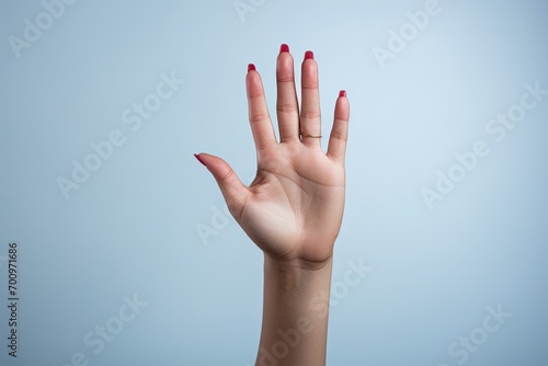 A woman signaling a stop or no gesture with her hand. photo