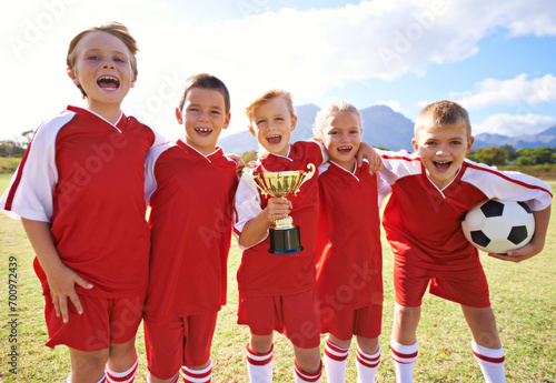 Victory, soccer team and children with cup, boys and girls with pride, support or proud. Achievement, sports and friendship, together and happy for win, ready for game and physical activity