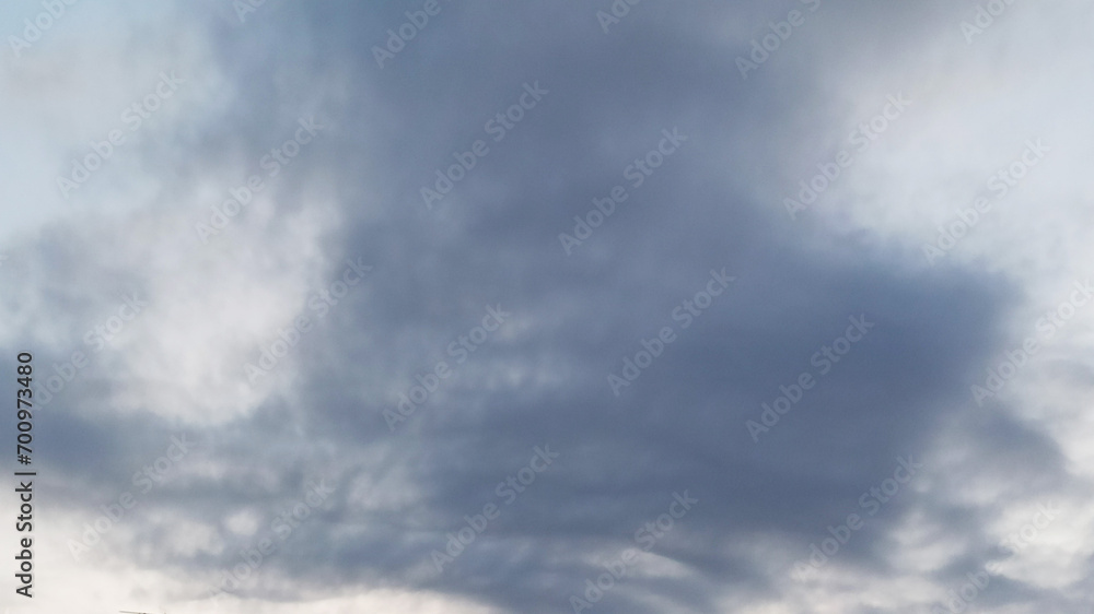 White fluffy clouds in the blue sky. Abstract background for design.