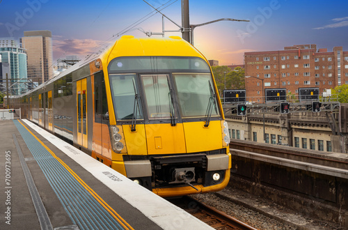 Commuter Train fast moving through a Station in Sydney NSW Australia locomotive electric light rail