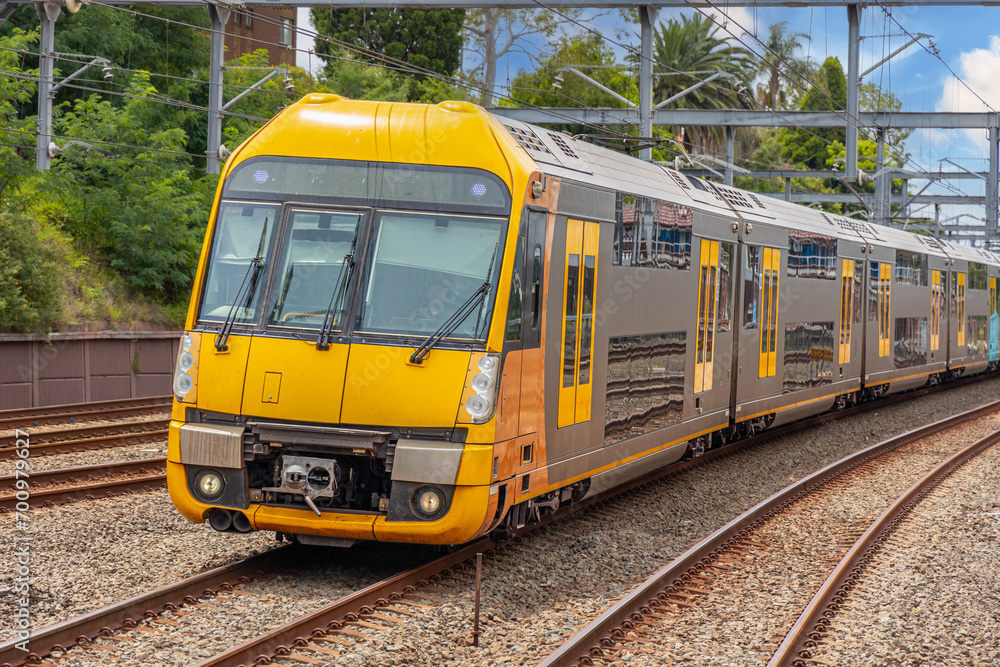 Commuter Train fast moving through a Station in Sydney NSW Australia locomotive electric light rail