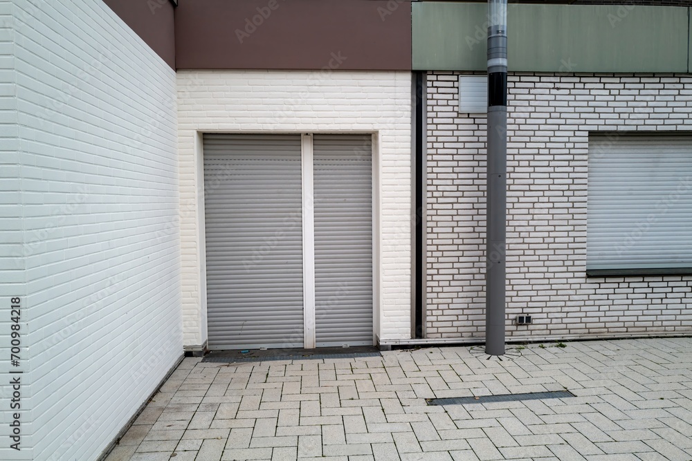 Building with windows and shutters, backyard corner Building with windows and shutters, backyard corner