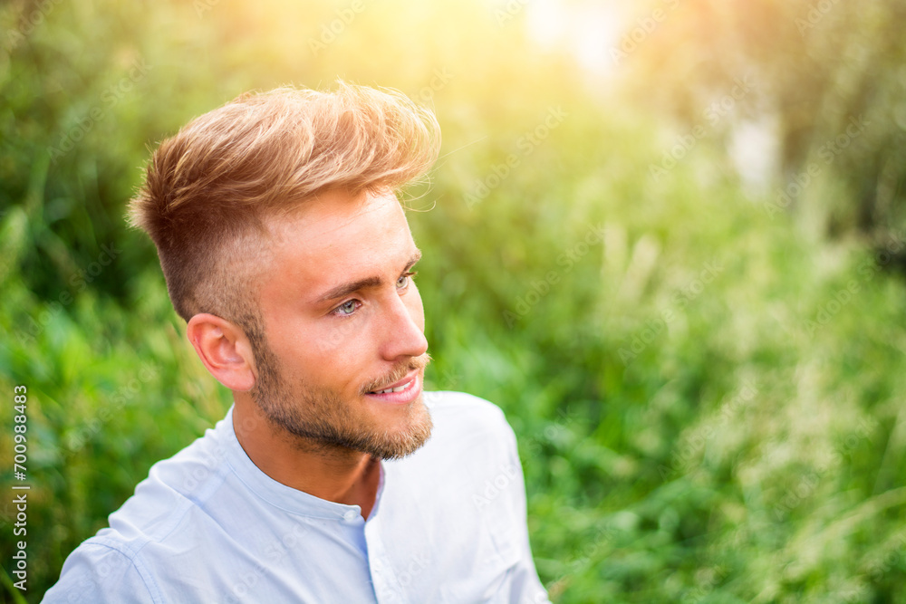 Good looking, young man relaxing lying on the grass Good looking, young man relaxing lying on the grass