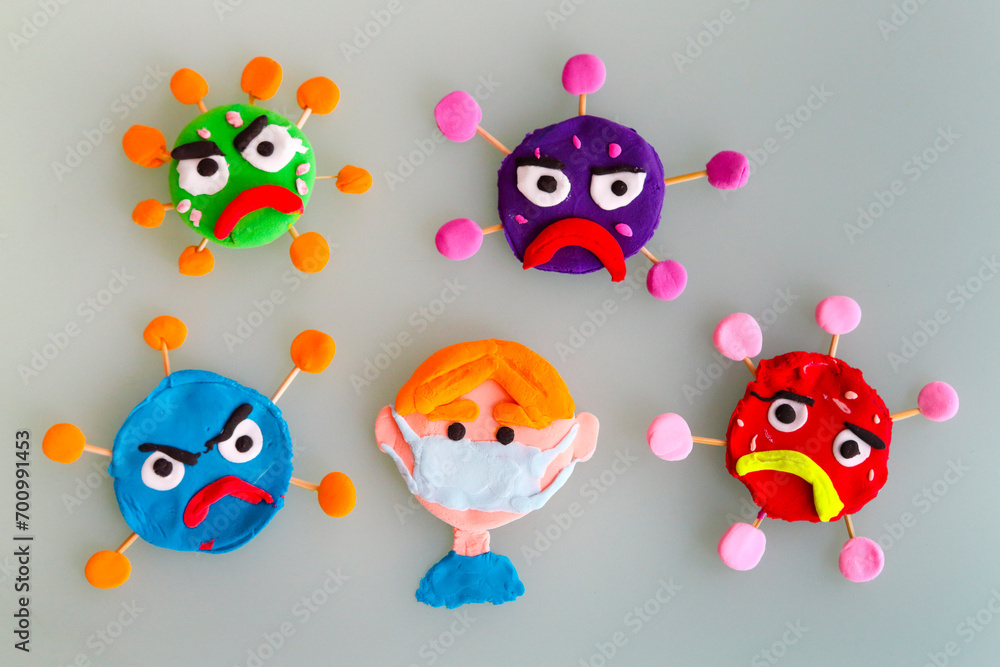Clay characters on gray background. Corona virus or covid-19