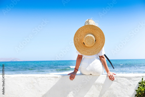Young happy blond woman at beautiful tropical paradise view of ocean enjoying summer holidays