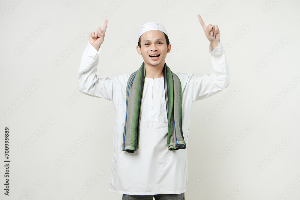 happy asian muslim man poitning finger gesture. People religious Islam lifestyle concept. celebration Ramadan and ied Mubarak. on isolated background.
