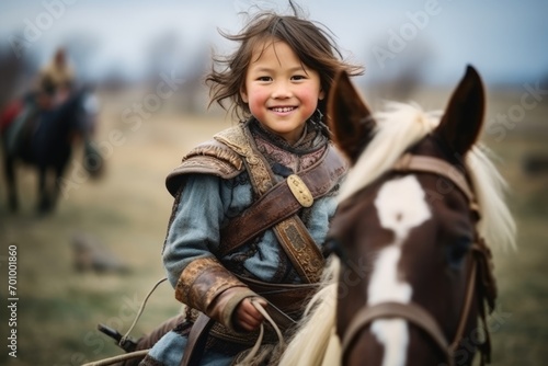 Cute little girl riding a horse in the countryside, shallow depth of field
