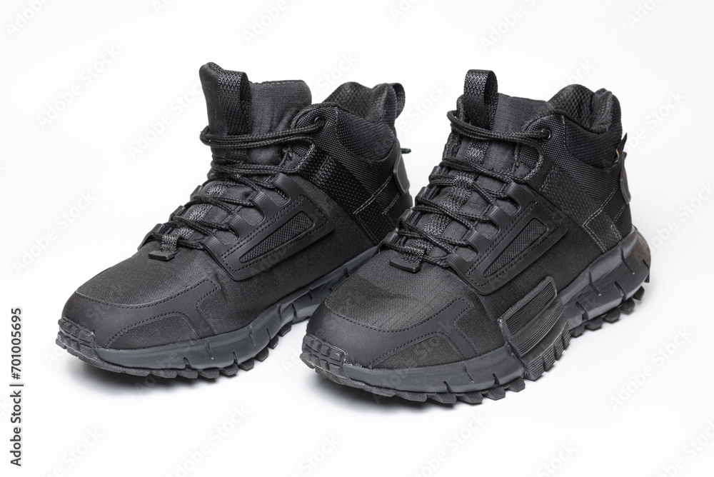 A pair of black winter sports boots on a white background. A pair of black winter sports boots on a white background.