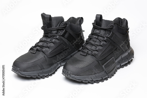 A pair of black winter sports boots on a white background.