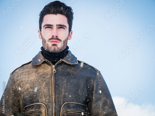 Handsome confident man in mountain with snow