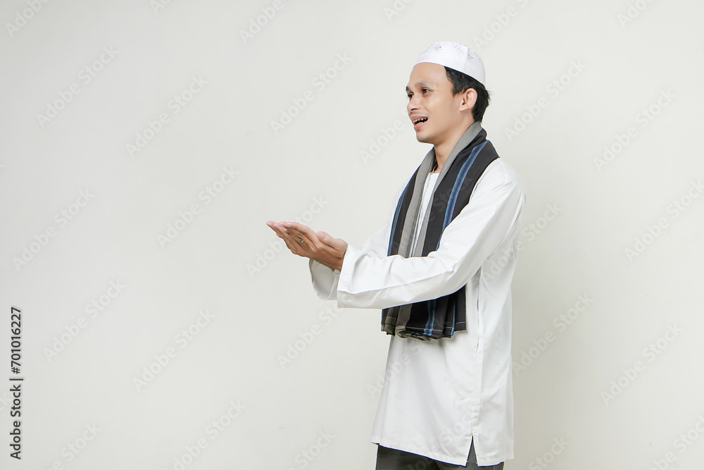 asian muslim man with presenting hand gesture. People religious Islam lifestyle concept. celebration Ramadan and ied Mubarak. on isolated background. asian muslim man with presenting hand gesture. People religious Islam lifestyle concept. celebration Ramadan and ied Mubarak. on isolated background.