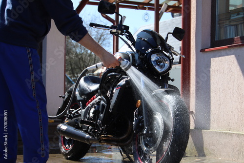 man wash motorcycle