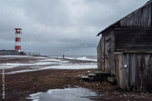 Dramatic seascape with a raging sea and a fishing hut on the sho