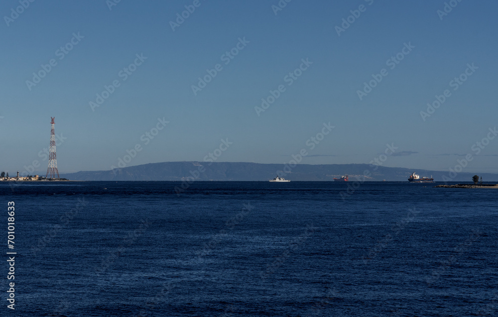 view of the narrow Strait of Messina between Sicily and mainland Italy and ships passing