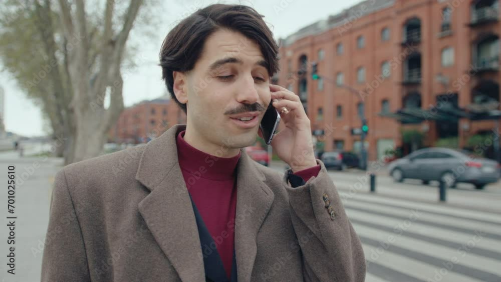 Young handsome man standing outdoors on the street and discussing business during autumn day in the city Young handsome man standing outdoors on the street and discussing business during autumn day in the city