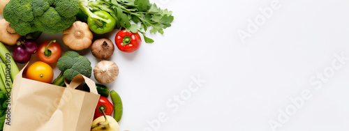 Healthy food in a paper bag of vegetables and fruits on white. photo