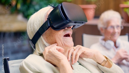 Fotografi Shocked old woman using Virtual reality goggles in a geriatric