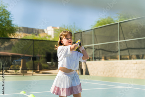 Sporty active girl having fun during a tennis match