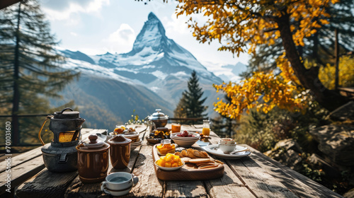 An outdoor dining setup overlooking the majestic matterhorn mountain, with a spread of breakfast  © Halim Karya Art