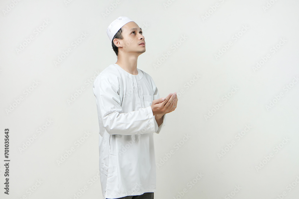 asian muslim man with praying hand gesture. holding palm face up. People religious Islam lifestyle concept. celebration Ramadan and ied Mubarak. on isolated background. asian muslim man with praying hand gesture. holding palm face up. People religious Islam lifestyle concept. celebration Ramadan and ied Mubarak. on isolated background.
