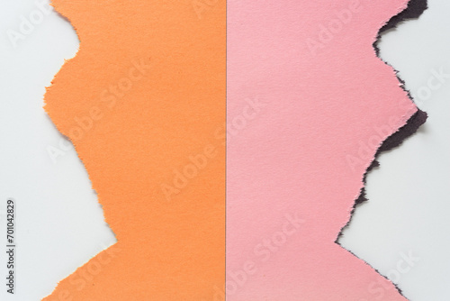 torn pink and orange construction paper sheets in near matchbook style on white