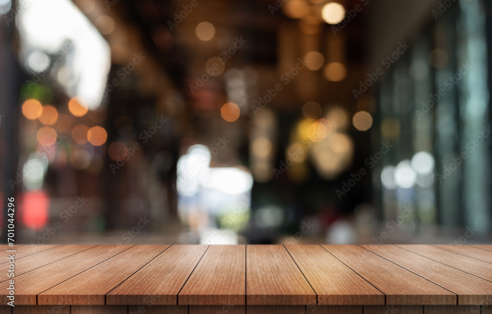 Empty wooden table top with lights bokeh on blur restaurant background. Empty wooden table top with lights bokeh on blur restaurant background.