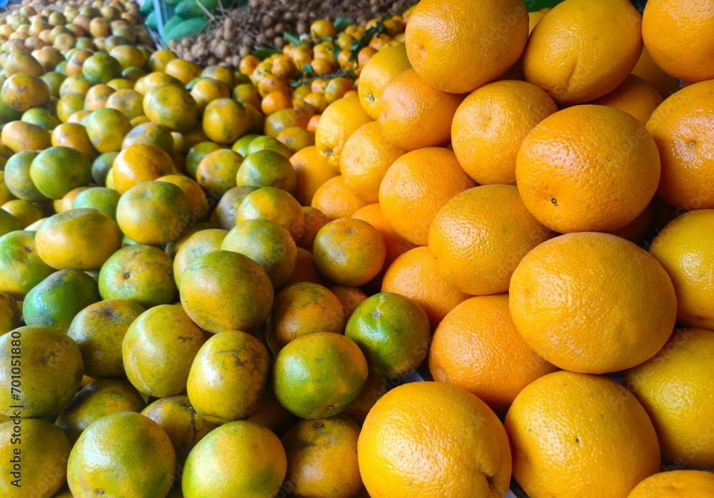 Stacks of citrus fruits of various types and sizes with sweet and sour tastes are sold in fruit shops