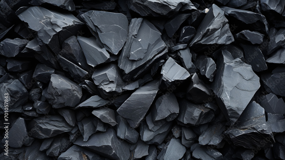 Sharp black rocks, slate shards, dark slate stones with sharp angles, pebble, gravel background texture, black and white