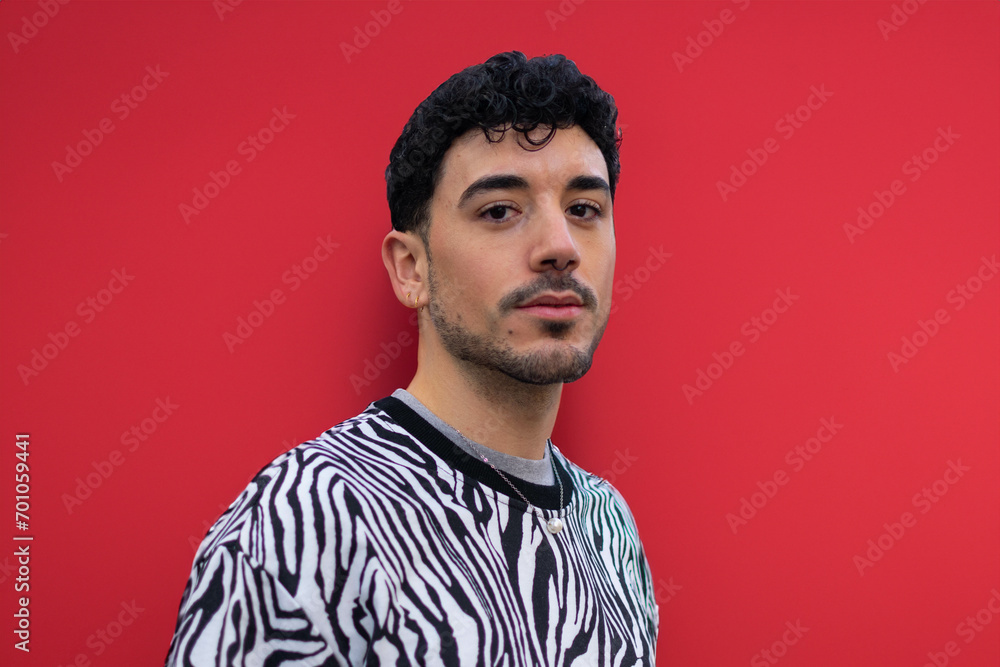 Obraz premium Bearded man with unshaven face and stylish haircut red background, hair