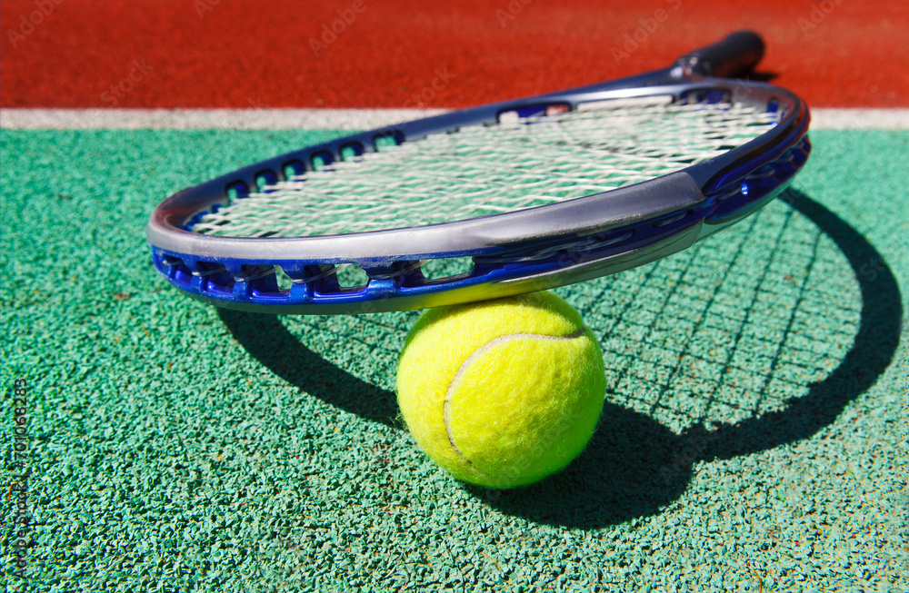 Close up of tennis racquet and ball