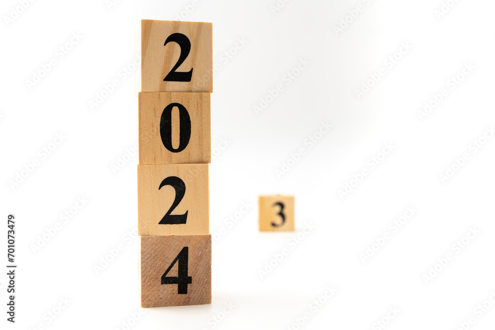 Number 2024 and number 3 written on wooden blocks in vertical direction isolated on white background Number 2024 and number 3 written on wooden blocks in vertical direction isolated on white background