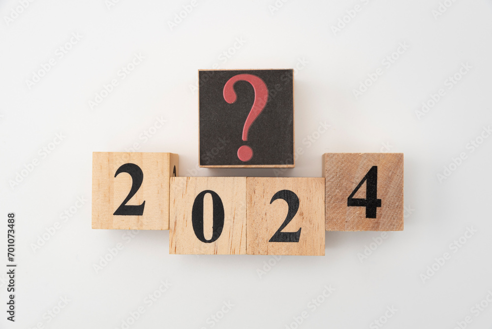 Number 2024 and question mark written on wooden blocks isolated on white background Number 2024 and question mark written on wooden blocks isolated on white background