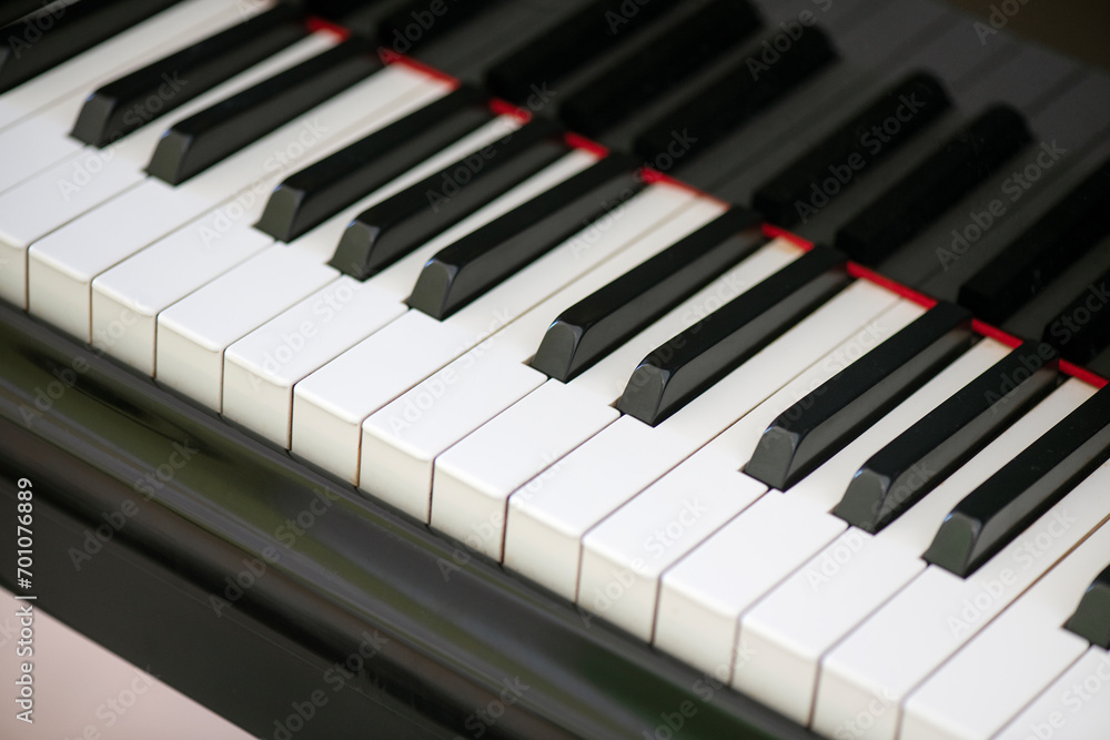 Piano keyboard close-up, displaying the meticulous arrangement of alternating ebony and ivory keys, music instrument fundamental in classical, jazz and other genres, due to its versatile sounds range