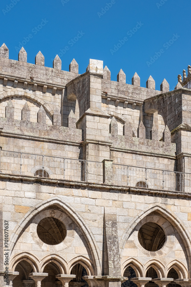 Detail of the Gothic architecture of the Se do Porto cathedral, showcasing intricate stonemasonry of the cloister arches, of roof spires and of flying buttresses in Porto, Portugal