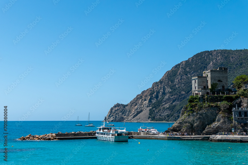 Monterosso, Italy, July 27, 2023. The castle and the tourist boat landing stage Monterosso, Italy, July 27, 2023. The castle and the tourist boat landing stage