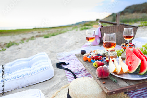 Picnic on the beach at sunset in the style of boho photo