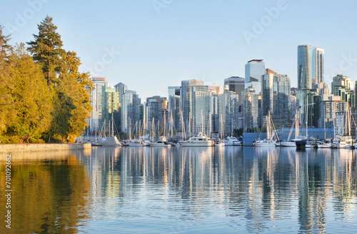 The Seawall and the skyline of Vancouver as seen from Stanley Park during a golden hour sunset in the fall in British Columbia, Canada photo