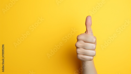 Close up photo of Woman hand thumb up with yellow background with Generative AI photo