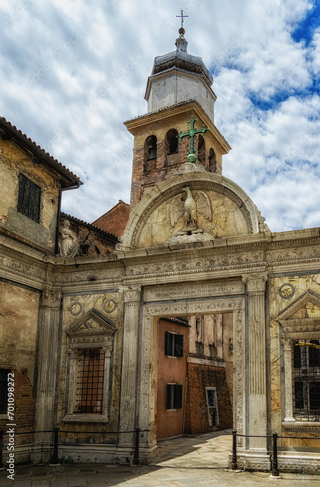 Old town of Venice with eagle and cross of Scuola Grande di San Giovanni Evangelista with church tower