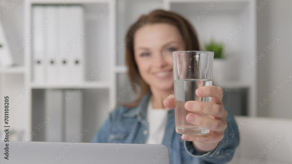 Positive and emotionally minded woman at home maintains her health through daily practice drinking water. Simple step towards happiness and well-being. Brings glass water to chamber offers to take it Positive and emotionally minded woman at home maintains her health through daily practice drinking water. Simple step towards happiness and well-being. Brings glass water to chamber offers to take it