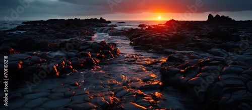 Dramatic sunset at  stony coast at sunset.