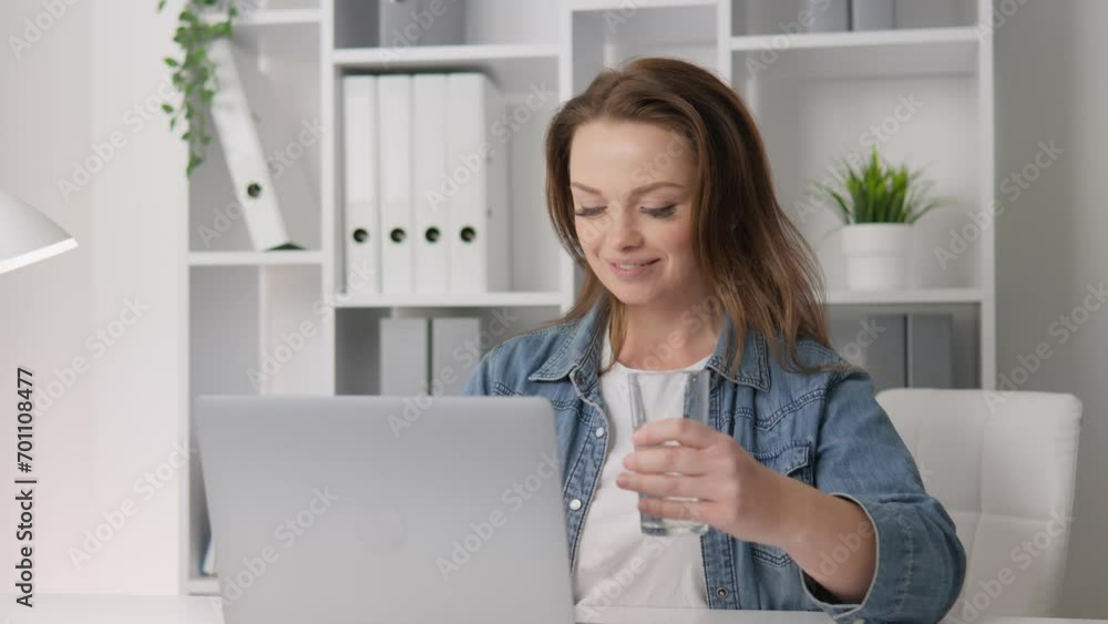 Attentive, happy woman working at home at computer smiling, drinking water during work hours, on vacation and creating her own hydration and water balance regimen Woman holding glass water in morning Attentive, happy woman working at home at computer smiling, drinking water during work hours, on vacation and creating her own hydration and water balance regimen Woman holding glass water in morning