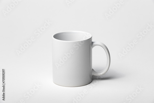 Mockup of a coffee cup or mug, white, isolated, on a plain background, ready to overlay designs or logos for merchandising