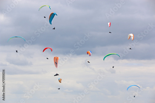 Paragliders flying in a cloudy sky