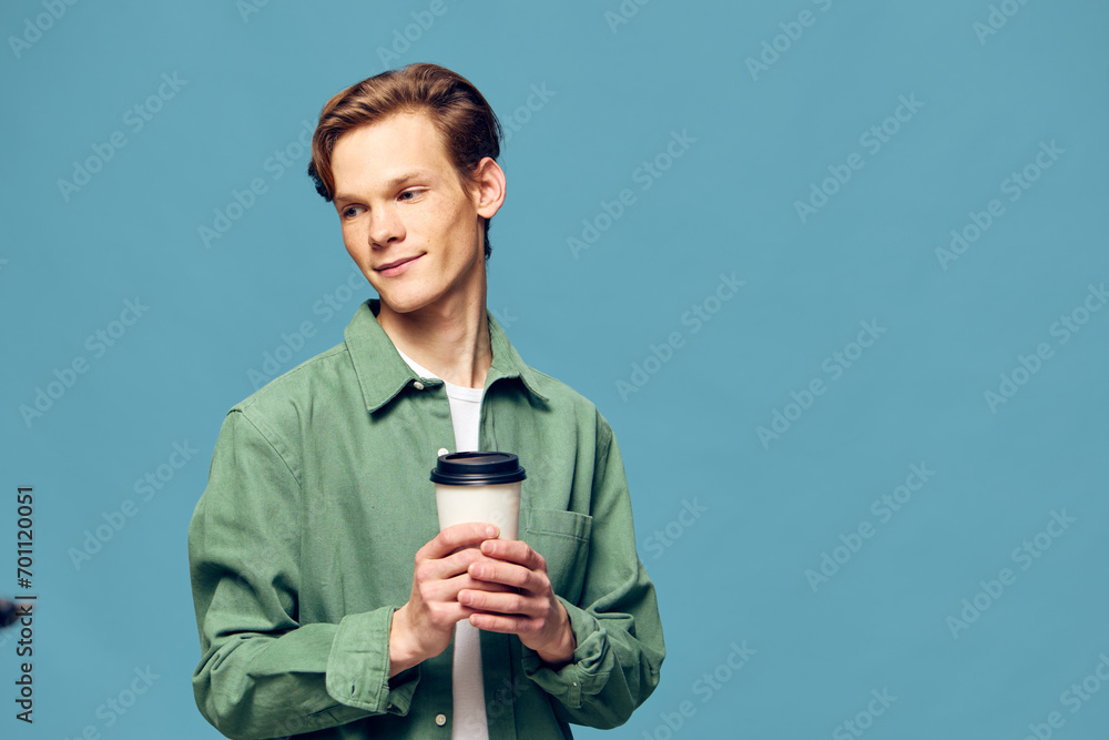 Trendy Young Caucasian Man with a Confident Smile Holding a Hot Cup of Coffee in a Modern Studio Trendy Young Caucasian Man with a Confident Smile Holding a Hot Cup of Coffee in a Modern Studio
