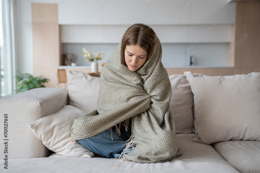 Desperated depressed woman crying sitting on couch with closed eyes wrapped in plaid. Girl suffering fom emotional pain having life troubles problems. Mental disorder, anhedonia, stress, sleepiness. Desperated depressed woman crying sitting on couch with closed eyes wrapped in plaid. Girl suffering fom emotional pain having life troubles problems. Mental disorder, anhedonia, stress, sleepiness.
