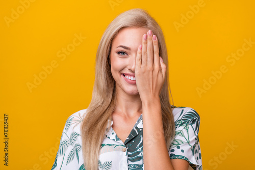 Portrait of positive cheerful woman with straight hairstyle wear stylish blouse palm cover eye isolated on yellow color background