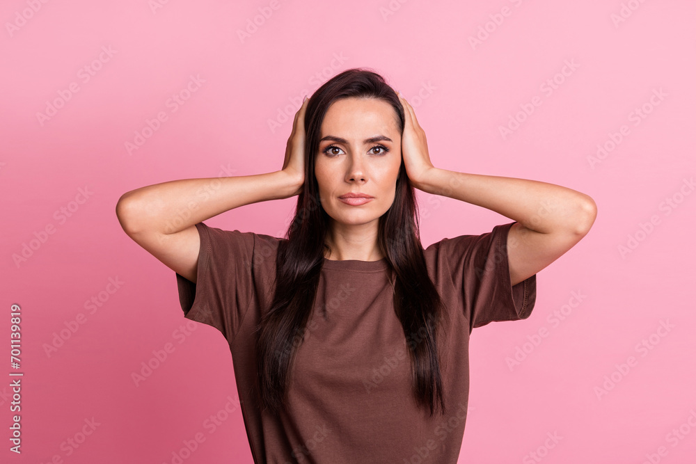 Portrait of focused concentrated person hands covering ears do not listen isolated on pink color background Portrait of focused concentrated person hands covering ears do not listen isolated on pink color background