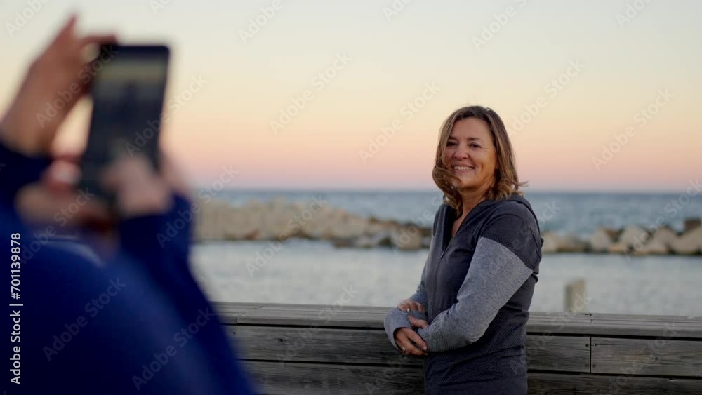 Video of a senior runners taking photos after exercising in a promenade during sunset Video of a senior runners taking photos after exercising in a promenade during sunset