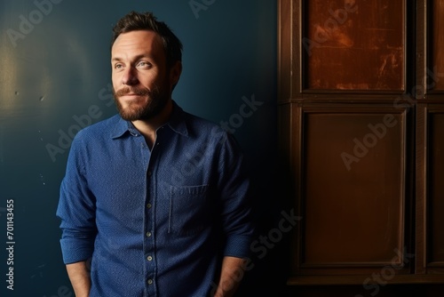 Portrait of a handsome man in a blue shirt. Studio shot. © Igor